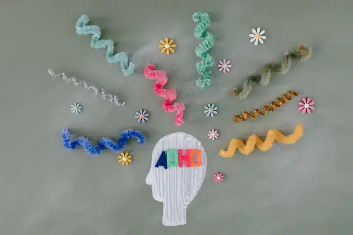 Concerta vs. Ritalin: colorful ADHD image showing a profile angle of a face cut from felt.