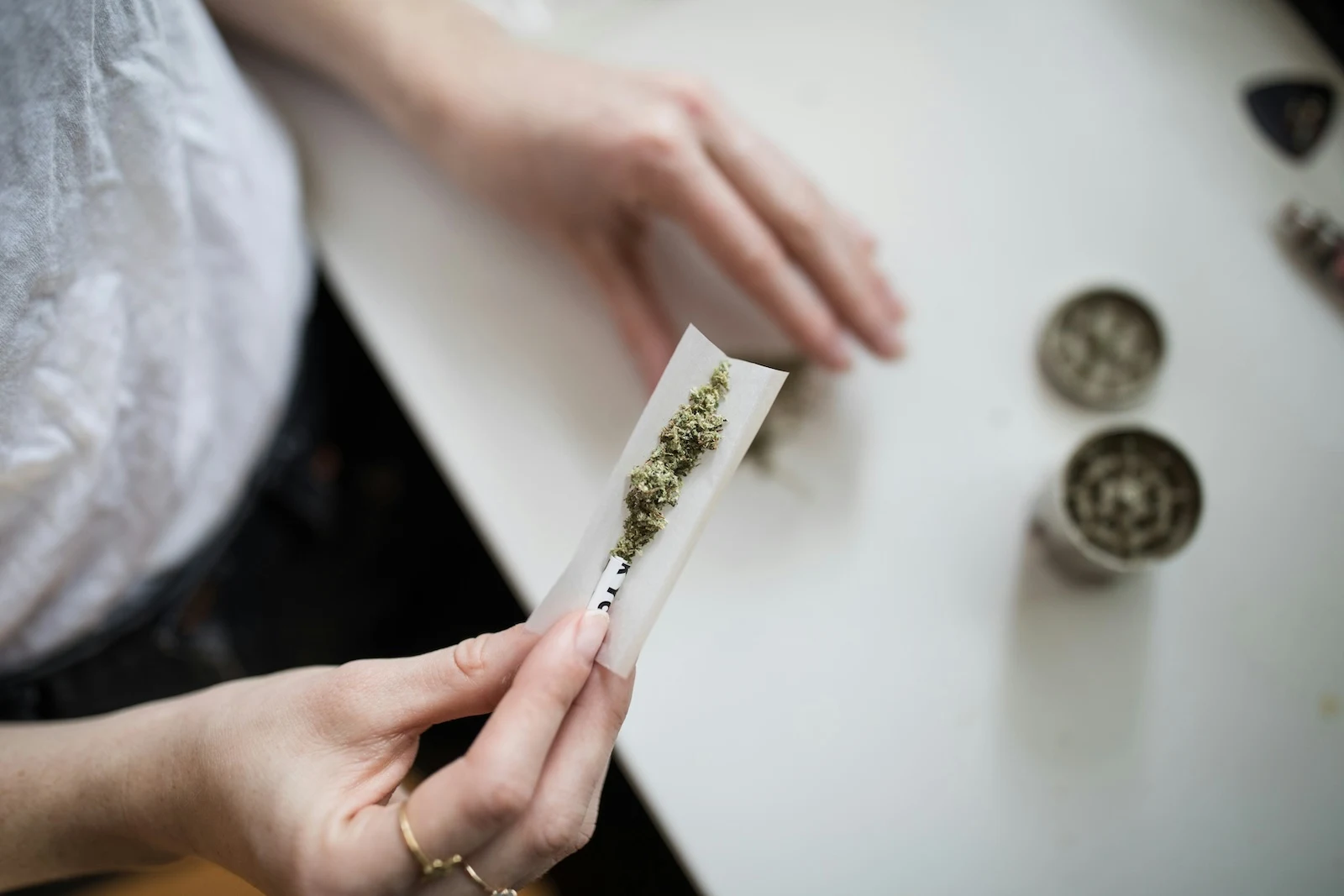 woman rolling a joint wonders how long weed withdrawal symptoms last