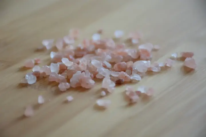 What Is Flakka? Pink and white crystals on a wooden surface.