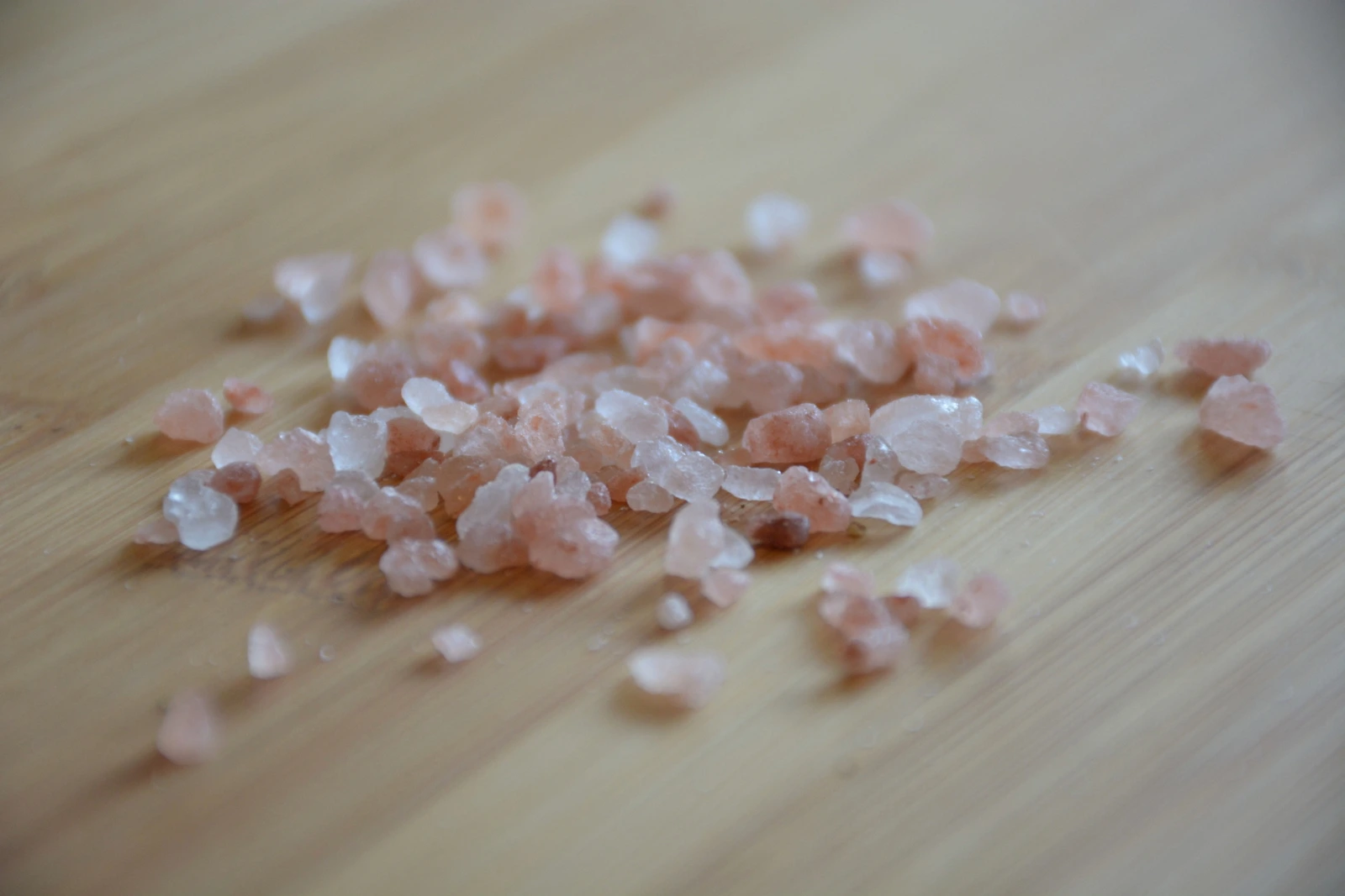What Is Flakka? Pink and white crystals on a wooden surface.