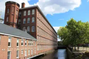 unnamed Lowell National Historical Park canal walkway beside a restored textile mill in Lowell, MA